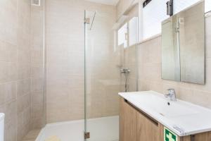 a bathroom with a sink and a shower at Cabanas de Tavira - Studio in Cabanas de Tavira