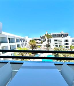 a balcony with a table and chairs and a building at Casa Pablo in Arona
