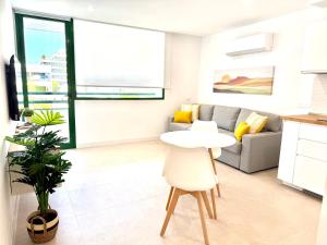 a living room with a table and a couch at Casa Pablo in Arona