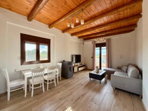 a living room with a couch and a table at Aristea Seaside Retreat with Private Pool in Kalamaki Heraklion
