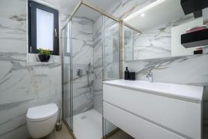 a white bathroom with a toilet and a sink at Luxury Penthouse Viki with seaview in Umag +13 photos