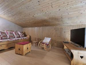 a bedroom with a bed and a flat screen tv at Appartement rénové 8 pers avec balcon, Le Grand-Bornand - FR-1-458-138 in Le Grand-Bornand