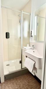 a bathroom with a shower and a sink at B&B HOTEL Lille Centre Grand Palais in Lille +52 photos
