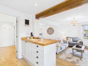 a kitchen with a large island in a living room at Corner House- hot tub and outdoor fireplace in Herstmonceux