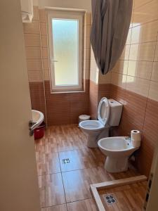 a bathroom with two toilets and a window at Studio holidays in Shëngjin +82 photos