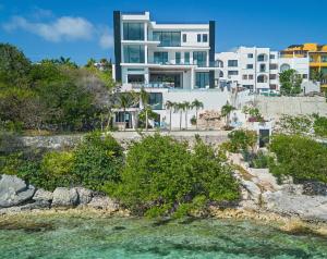a view of a building from the water at Spectacular New Oceanfront Villa Isla Mujeres in Isla Mujeres