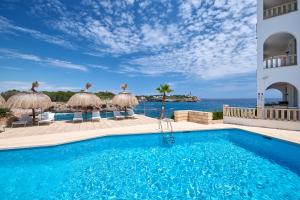 a swimming pool with a view of the ocean at Orange Colom - Seaside Apartments in Portocolom