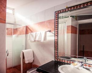 a bathroom with a sink and a mirror at Limanaki Apartments in Faliraki