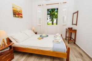 Ένα ή περισσότερα κρεβάτια σε δωμάτιο στο George & Danai apartments