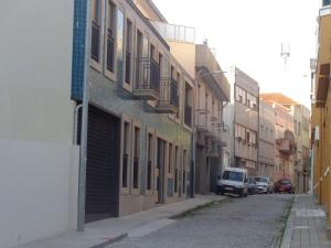 a city street with cars parked in front of it at Portuense Alojamento Local in Porto