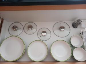 a stove top with four silver knobs on it at Aquarosa Apartman in Hévíz +20 photos