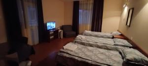 Postel nebo postele na pokoji v ubytování Matev Hotel