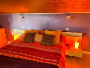 a bedroom with a large bed with two lamps at Chambre Viviane in Néant-sur-Yvel