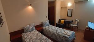 Postel nebo postele na pokoji v ubytování Matev Hotel