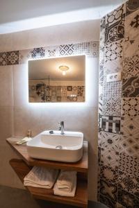 a bathroom with a sink and a mirror at Dorče Authentic Country House in Kojsko