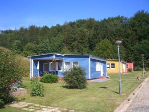 a blue house on a hill with a street light at Chausseehaus - Ferienwohnungen Rottleberode am Harzrand in Rottleberode