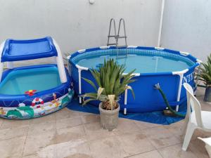 twolatablelatable pools in a room with a table and a plant at Riyadh Salman Villa فيلا in Riyadh