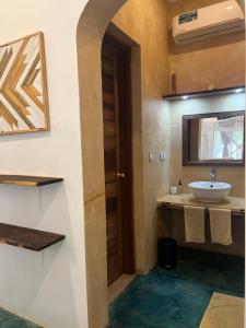 a bathroom with a sink and a mirror at Siri Beach Lodge in Nungwi