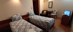 Postel nebo postele na pokoji v ubytování Matev Hotel