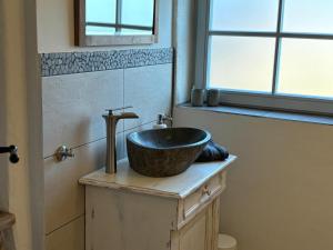 a bathroom with a sink on top of a counter at Gast- und Pensionshaus Pilgereck in Trendelburg +27 photos