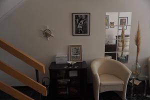a living room with a chair and a staircase at Guesthouse Villa Stanger 2 in Lovran