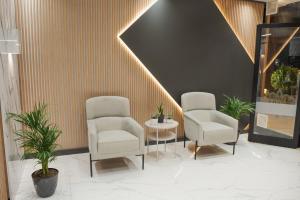 two chairs and a table in a room with plants at Yusra Apart Otel in Trabzon +45 photos