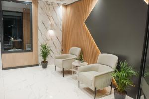 a waiting room with two chairs and a table at Yusra Apart Otel in Trabzon +42 photos