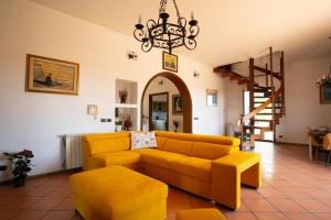 a living room with a couch and a chandelier at Silvanae Pool Villa in Aci Castello +40 photos