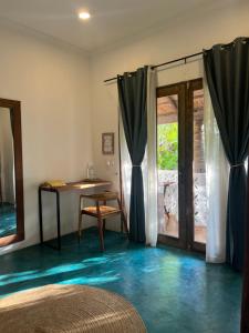 a room with blue floors and a table and a window at Siri Beach Lodge in Nungwi