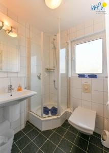 a bathroom with a shower and a sink at Ferienhaus Caterlieschen Ferienwohnung 1 in Juist +26 photos