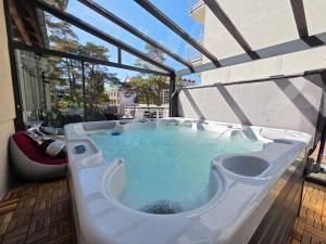 a jacuzzi tub on the balcony of a building at Villa Azalia in Jastrzębia Góra