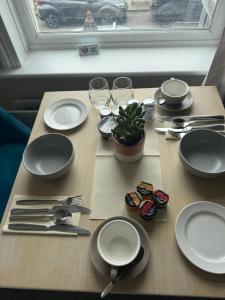 a table with plates and utensils on top of it at The Ship Inn - Sandgate in Folkestone +22 photos