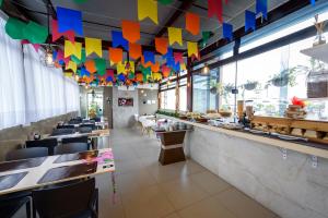 a restaurant with colorful flags hanging from the ceiling at Hotel Mais1 in Campina Grande