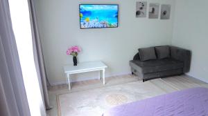 a living room with a chair and a table at 1комн апартаменты на Океане у Галины in Semey