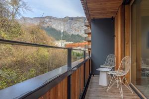 a balcony with chairs and a view of the mountains at Edelweiss Ferienwohnung, Vista Flem in Flims