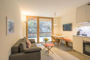 a living room with a couch and a table at Edelweiss Ferienwohnung, Stenna Flims in Flims