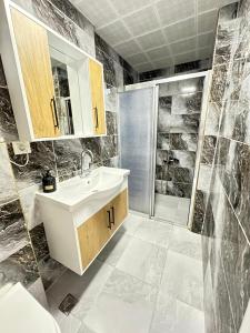 a bathroom with a sink and a shower at Upart Flats by REFE in Antalya