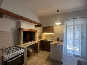 a kitchen with a stove top oven next to a window at Il FONTANONE in Veiano