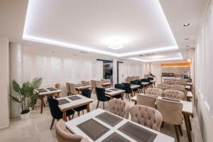 a restaurant with tables and chairs in a room at The Lord's Garden in Ksamil