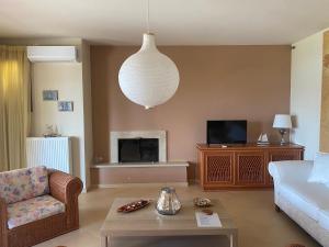 A television and/or entertainment centre at House with View in Amfithea
