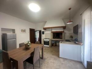 a kitchen with a wooden table and a dining room at Il FONTANONE in Veiano +19 photos