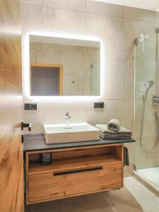 a bathroom with a sink and a mirror at Landhaus Altweck in Wegscheid