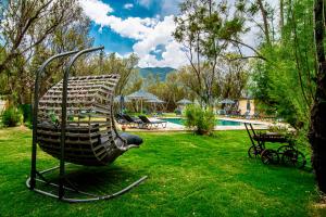 a sculpture of a chair in a yard with a pool at Nest Beach Bungalows and Camping Datça in Datca +17 photos