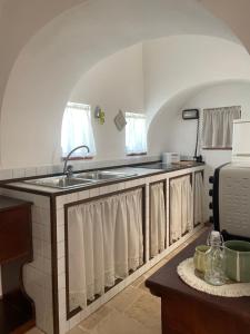 a kitchen with a sink and a counter at I Trulli di Mimì in Monopoli