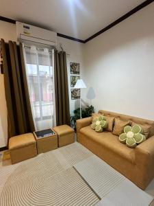 a living room with a couch and a window at A and A Homestay Tandag City 