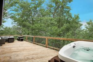 a bathroom with a bath tub on a wooden deck at Valley Views Hot Tub Deck Screened Porch & WiFi in Hedgesville