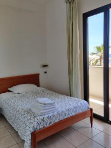 Postel nebo postele na pokoji v ubytování Hotel Stella del Tirreno