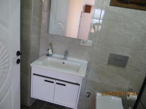 a bathroom with a white sink and a mirror at Stella Blu Apartments in Fethiye +22 photos