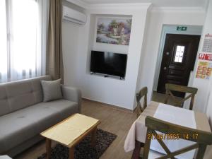 a living room with a couch and a table at Stella Blu Apartments in Fethiye
