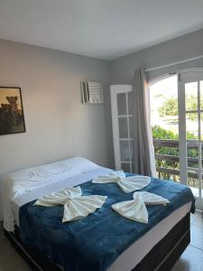 Cama ou camas em um quarto em Pousada e Hostel Arauna